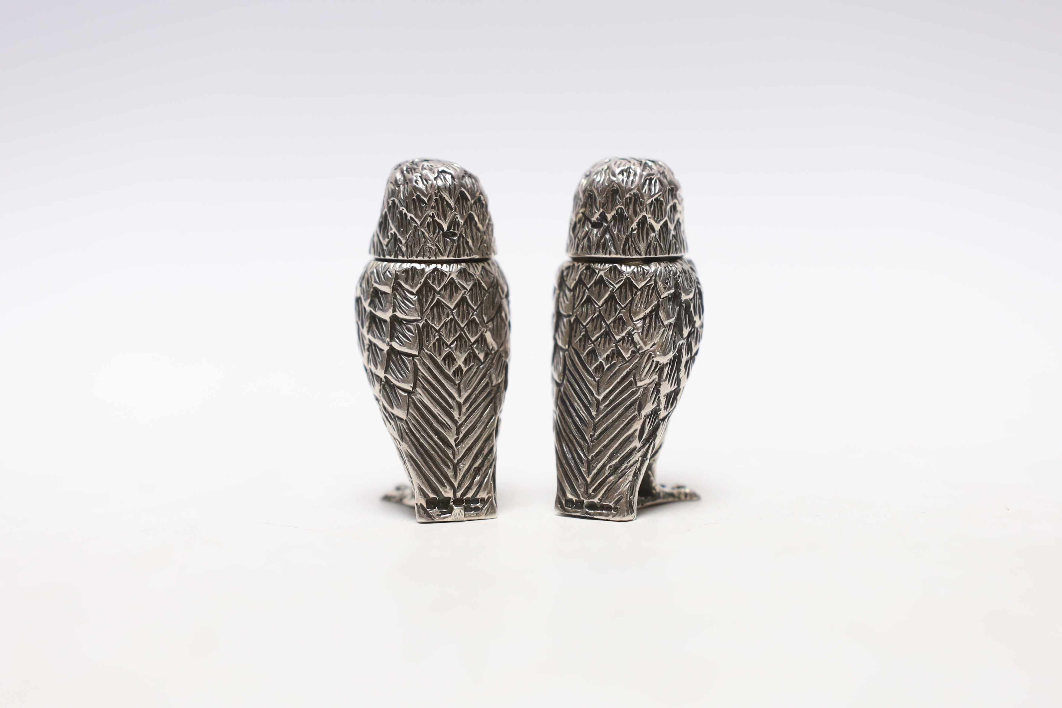 A pair of Elizabeth II novelty silver condiments, each modelled as an owl, maker WW, London, 2008, 51mm.